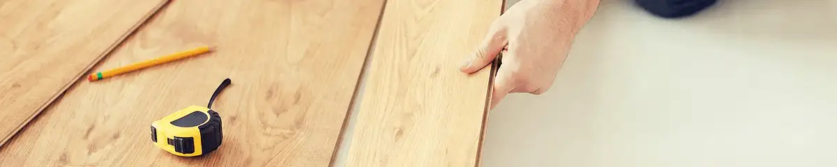 A professional installing wood flooring in Anaheim, CA