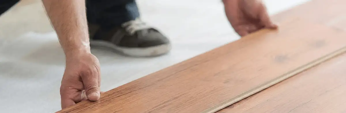 A professional installing laminate flooring in Anaheim, CA